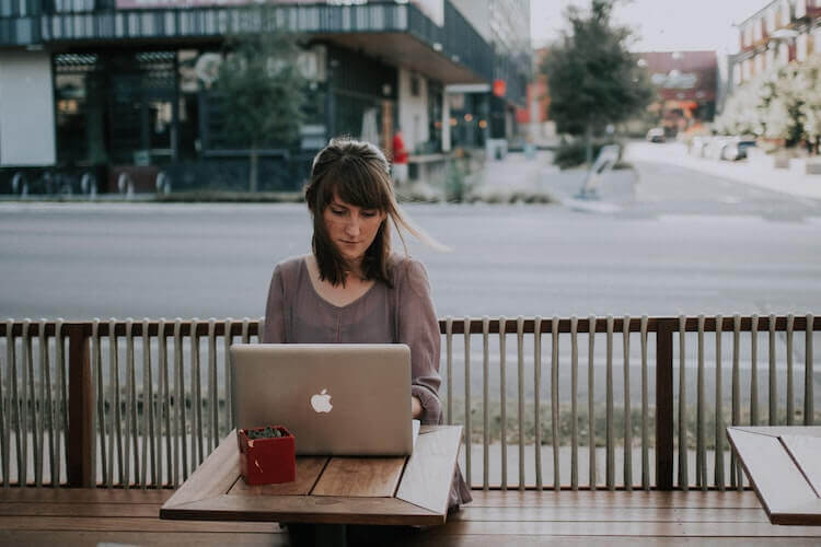 Sell on Amazon for free: woman working on her laptop at a cafe